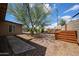 Backyard featuring rock ground cover, landscaping, and a wooden storage box next to the home's exterior at 322 N Williams St, Mesa, AZ 85203