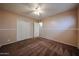 Bedroom with plush carpet flooring, a ceiling fan, and a double-door closet at 322 N Williams St, Mesa, AZ 85203
