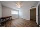 Bright bedroom featuring wood floors, a ceiling fan, large window and closet at 322 N Williams St, Mesa, AZ 85203