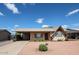 Charming single-story home with covered parking, a low maintenance yard, and beautiful blue skies above at 322 N Williams St, Mesa, AZ 85203