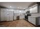 Updated kitchen with stainless steel appliances, white cabinets, and subway tile backsplash at 322 N Williams St, Mesa, AZ 85203