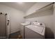 Convenient laundry room featuring a washer, dryer, and overhead shelving at 322 N Williams St, Mesa, AZ 85203