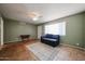 Open-concept living room with light green walls, tan tile flooring, and a ceiling fan at 322 N Williams St, Mesa, AZ 85203
