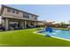 Sprawling backyard featuring a swimming pool, patio, and a hot tub offering an ideal outdoor experience at 3408 E Daley Ln, Phoenix, AZ 85050