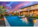 Picturesque backyard featuring a sparkling pool with water features and lush green lawn at 3408 E Daley Ln, Phoenix, AZ 85050