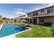 Expansive backyard oasis with a sparkling pool, plush turf, and a covered patio for relaxation and entertainment at 3408 E Daley Ln, Phoenix, AZ 85050