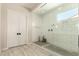 Modern bathroom featuring a glass-enclosed shower with white subway tile and neutral-tone flooring at 3408 E Daley Ln, Phoenix, AZ 85050