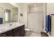 Bathroom featuring a dark wood vanity with double sinks and a shower with a curtain at 3408 E Daley Ln, Phoenix, AZ 85050