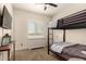 Bedroom with a black metal bunk bed, plantation shutters, and a white dresser at 3408 E Daley Ln, Phoenix, AZ 85050