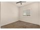 Empty bedroom featuring neutral carpet, plantation shutters and lots of natural light at 3408 E Daley Ln, Phoenix, AZ 85050