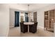 Light and bright dining room features elegant chandelier, stylish furniture, and attractive built-in cabinet at 3408 E Daley Ln, Phoenix, AZ 85050