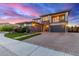 Beautifully landscaped two-story home with a brick driveway leading to a two-car garage at 3408 E Daley Ln, Phoenix, AZ 85050