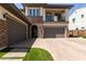 Home featuring a two-car garage and well designed brick and facade at 3408 E Daley Ln, Phoenix, AZ 85050