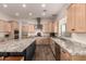 Gourmet kitchen with stainless steel appliances, granite countertops, and wooden cabinetry at 3408 E Daley Ln, Phoenix, AZ 85050