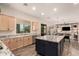 Open kitchen with granite countertops, a center island, and seamless access to the dining area at 3408 E Daley Ln, Phoenix, AZ 85050