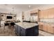 Open kitchen featuring stainless steel appliances, a center island, and seamless layout to dining area at 3408 E Daley Ln, Phoenix, AZ 85050