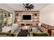Comfortable living room with a modern entertainment center, stylish furniture, and a ceiling fan at 3408 E Daley Ln, Phoenix, AZ 85050