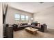 Comfortable living room boasts a large sectional sofa, stylish coffee table, and great natural light at 3408 E Daley Ln, Phoenix, AZ 85050