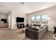 Inviting living room showcases a large sectional sofa, modern TV setup, and nice natural light at 3408 E Daley Ln, Phoenix, AZ 85050