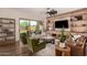 Bright living room featuring a built-in entertainment center, modern furniture, and backyard access at 3408 E Daley Ln, Phoenix, AZ 85050