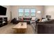 Cozy living room features a large sectional sofa, modern coffee table, and great natural light at 3408 E Daley Ln, Phoenix, AZ 85050