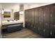 Modern locker room featuring lockers, bench seating and a vanity at 3408 E Daley Ln, Phoenix, AZ 85050