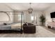 Bright bedroom with chandelier, sitting area, and balcony access offering a relaxing retreat at 3408 E Daley Ln, Phoenix, AZ 85050