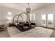 Spacious bedroom with a decorative chandelier, stylish furniture, and French doors leading to balcony at 3408 E Daley Ln, Phoenix, AZ 85050