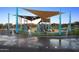 Community playground with splashpad area and covered play structures at 3408 E Daley Ln, Phoenix, AZ 85050