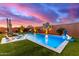 Backyard pool with water features, lounge chairs, and lush landscaping, perfect for relaxation at 3408 E Daley Ln, Phoenix, AZ 85050