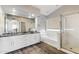 Renovated bathroom boasts a double vanity, vessel sinks, a soaking tub, and a glass shower at 3641 E Park Ave, Phoenix, AZ 85044