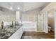 Spacious bathroom with vessel sinks, a soaking tub with window, and glass enclosed shower at 3641 E Park Ave, Phoenix, AZ 85044