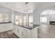 The modern kitchen island features black marble countertops, stainless appliances, and white cabinets at 3641 E Park Ave, Phoenix, AZ 85044