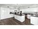 Spacious kitchen featuring white cabinets, a large center island, and stainless steel appliances at 3641 E Park Ave, Phoenix, AZ 85044
