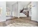 Bright living room with hardwood floors, high ceilings, large windows, and an open staircase at 3641 E Park Ave, Phoenix, AZ 85044