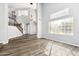 Bright open-concept living room with hardwood floors, staircase, high ceilings, and large windows at 3641 E Park Ave, Phoenix, AZ 85044
