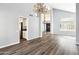 Living room featuring soaring ceilings, wood floors, and a view into the kitchen at 3641 E Park Ave, Phoenix, AZ 85044