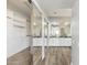 Walk-in closet featuring wood look floors, a full length mirror, and a full length vanity with bowl sinks at 3641 E Park Ave, Phoenix, AZ 85044