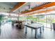 Game room with pool table, leather couches, wood-look floors and many windows with views to the outside at 3983 E Melinda Dr, Phoenix, AZ 85050