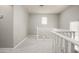 Upstairs hallway with carpeted flooring and white railing to the first floor at 3983 E Melinda Dr, Phoenix, AZ 85050