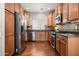 Modern kitchen boasts stainless steel appliances and warm wood cabinets at 3983 E Melinda Dr, Phoenix, AZ 85050