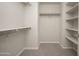 Carpeted walk-in closet with multiple levels of shelving and racks at 3983 E Melinda Dr, Phoenix, AZ 85050