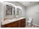 This bathroom has a double sink and hard wood laminate flooring at 405 W Monte Way, Phoenix, AZ 85041