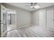 Neutral bedroom with tile floors, a ceiling fan, a closet with sliding doors and an adjacent room at 405 W Monte Way, Phoenix, AZ 85041