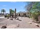 Charming single-story home featuring desert landscaping, mature trees, and a welcoming front porch at 405 W Monte Way, Phoenix, AZ 85041