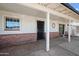 Inviting covered front porch with brick accents and neutral colors at 405 W Monte Way, Phoenix, AZ 85041