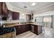 Well-lit kitchen with granite countertops, stainless steel appliances, and wood cabinets at 405 W Monte Way, Phoenix, AZ 85041