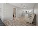 Open living area with modern flooring and convenient access to a half bathroom at 405 W Monte Way, Phoenix, AZ 85041