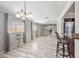 Bright living room with updated tile flooring, modern lighting, and neutral paint at 405 W Monte Way, Phoenix, AZ 85041