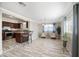 Open-concept kitchen and living room featuring sleek tile floors and plenty of natural light at 405 W Monte Way, Phoenix, AZ 85041